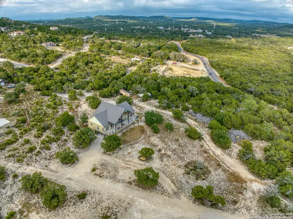 a view of a house with a yard and mountains