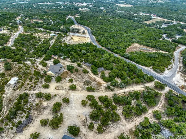 a view of a large house with a yard and plants