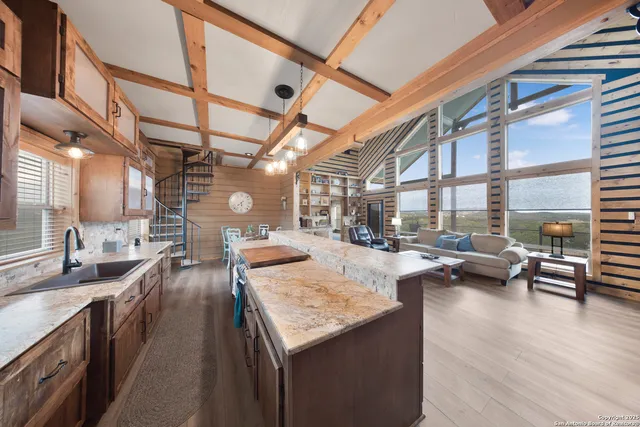 a kitchen with sink and view of living room