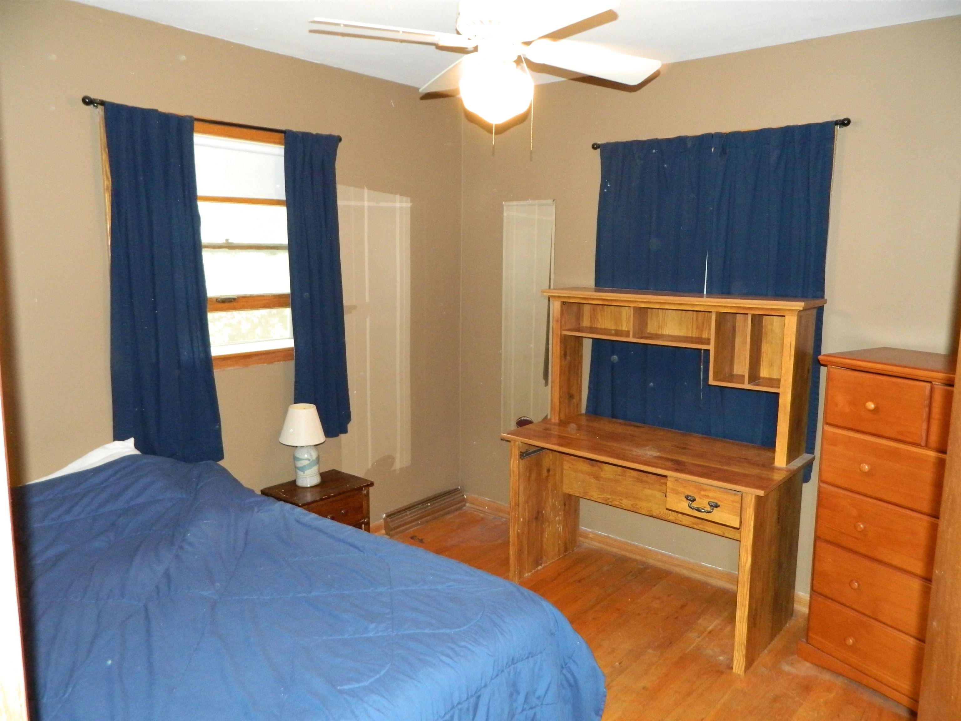 3834 Abbotsford Road Rockford, IL 61107 - Photo 16 of 25 a bedroom with a bed and wooden floor