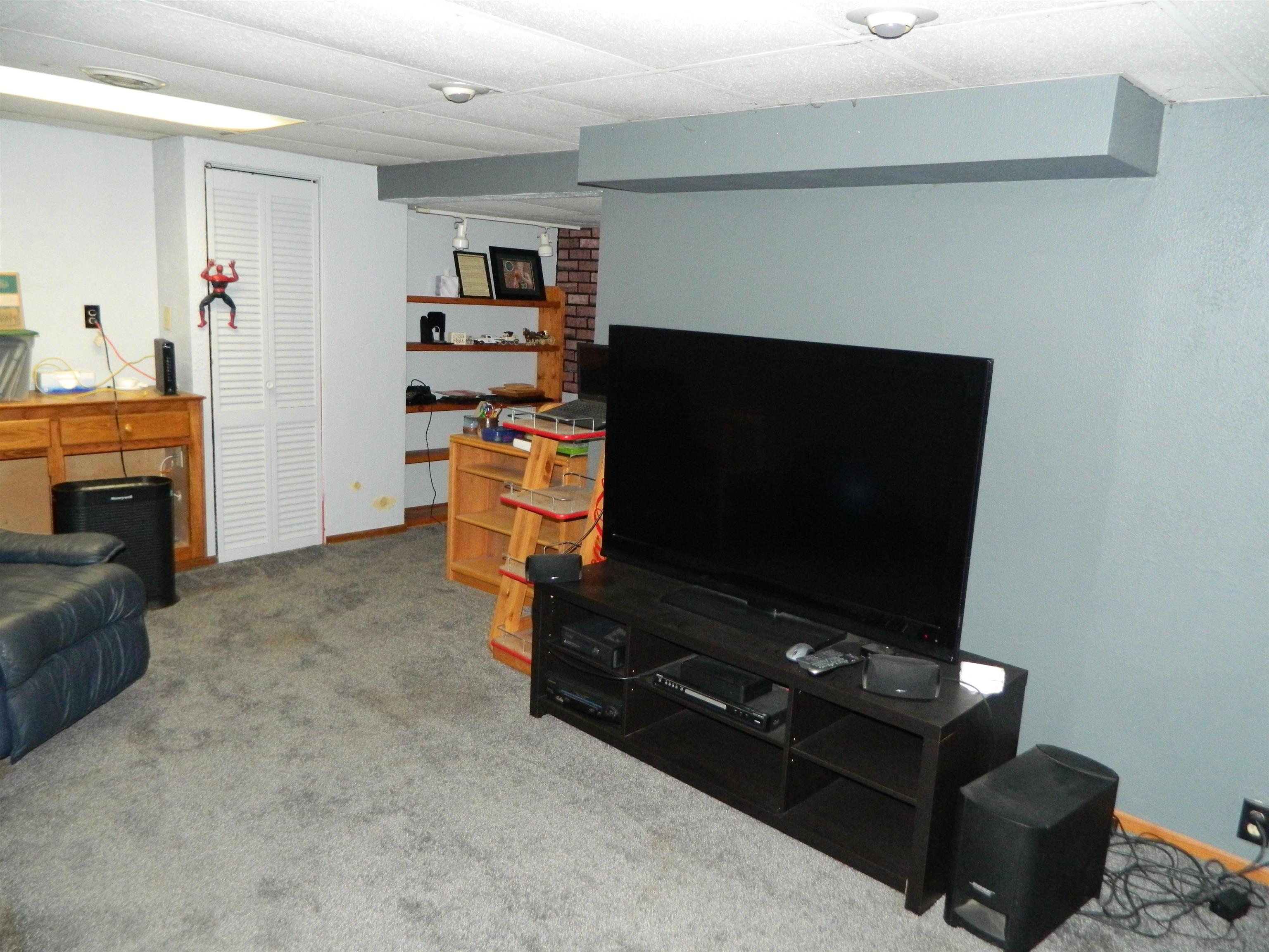3834 Abbotsford Road Rockford, IL 61107 - Photo 19 of 25 a living room with furniture and a flat screen tv
