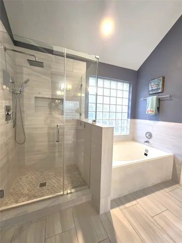 a bathroom with a bathtub and a shower