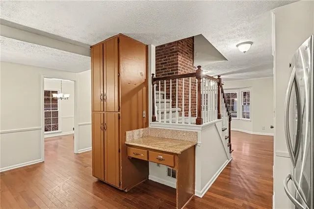 an empty room with wooden floor and a bathroom