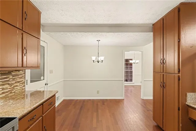 a view of a refrigerator in kitchen and wooden floor