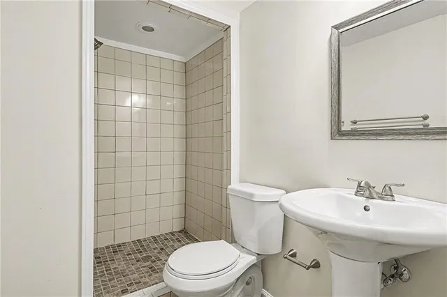 a white toilet sitting next to a bathroom sink