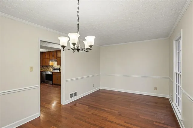 a view of a room with wooden floor