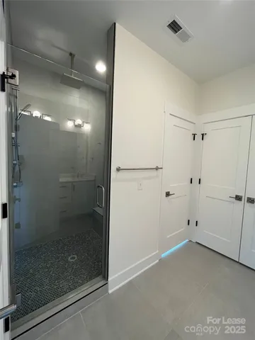 a spacious bathroom with a double vanity sink a mirror and a bathtub