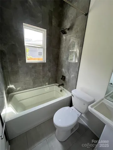 a bathroom with a toilet sink and a mirror