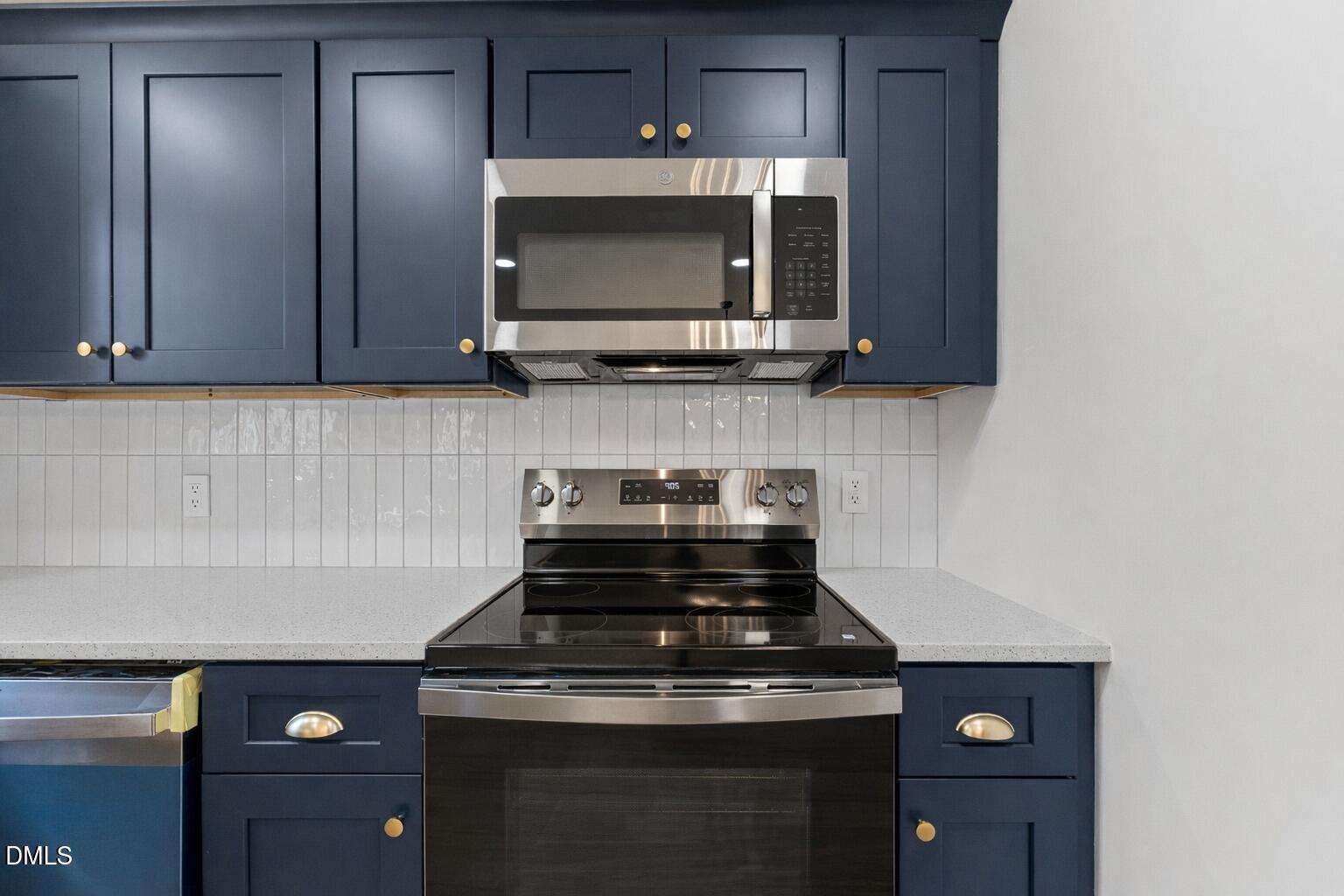 103 Callaway Lane Selma, NC 27576 - Photo 11 of 43 a kitchen with a stove and a microwave