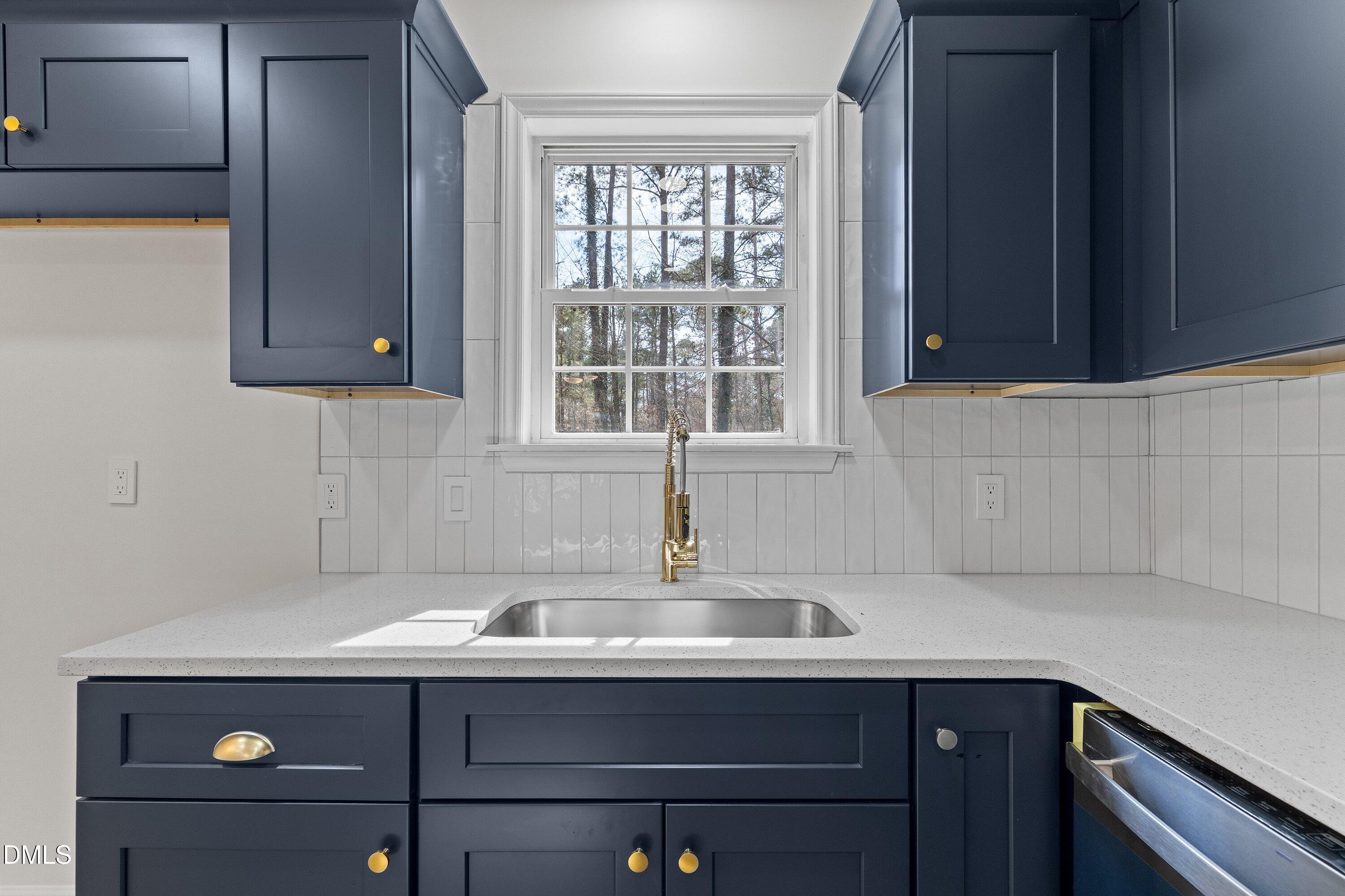 103 Callaway Lane Selma, NC 27576 - Photo 14 of 43 a view of cabinets a sink and a window