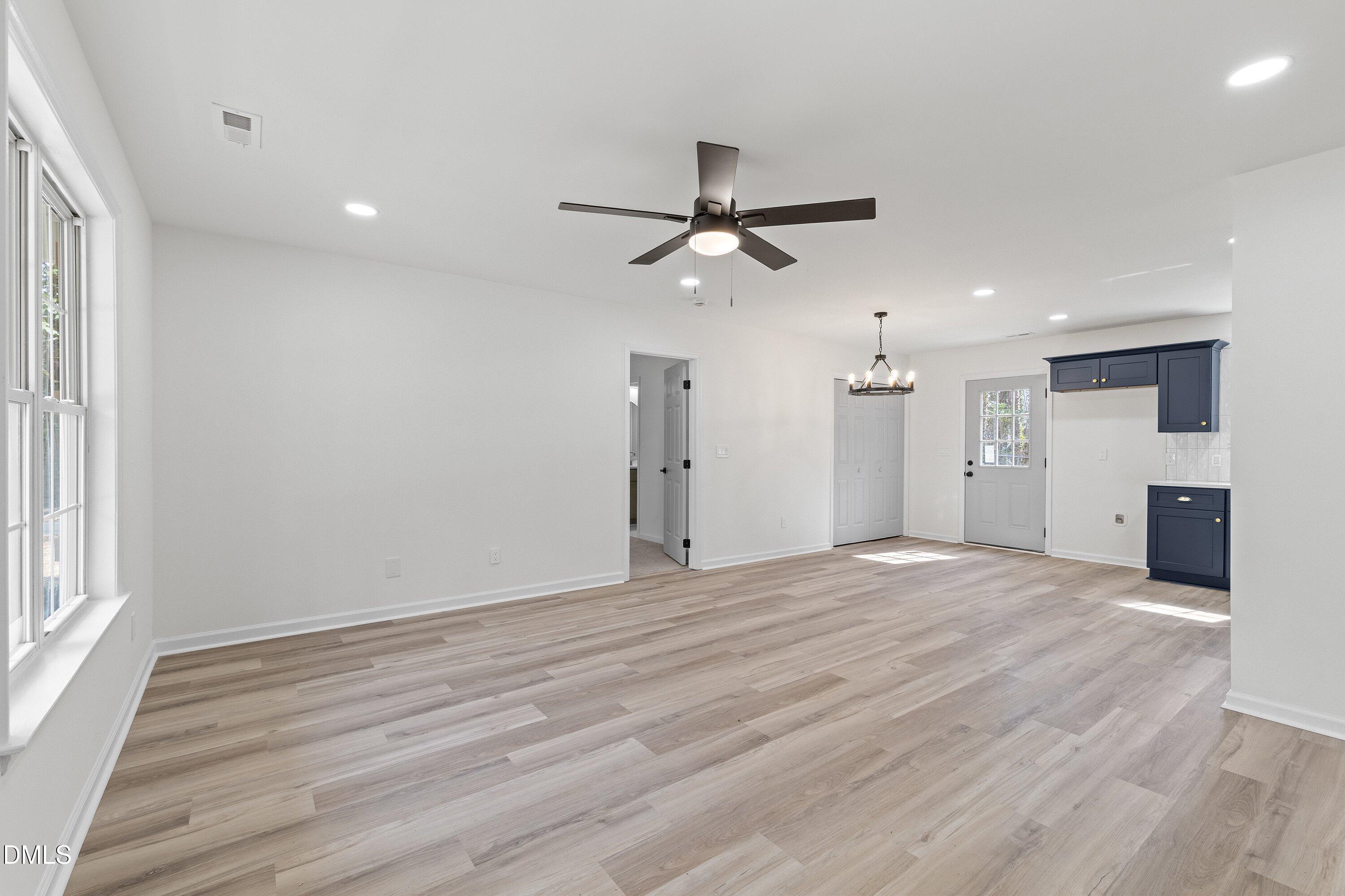 103 Callaway Lane Selma, NC 27576 - Photo 17 of 43 a view of a livingroom with a ceiling fan window and wooden floor