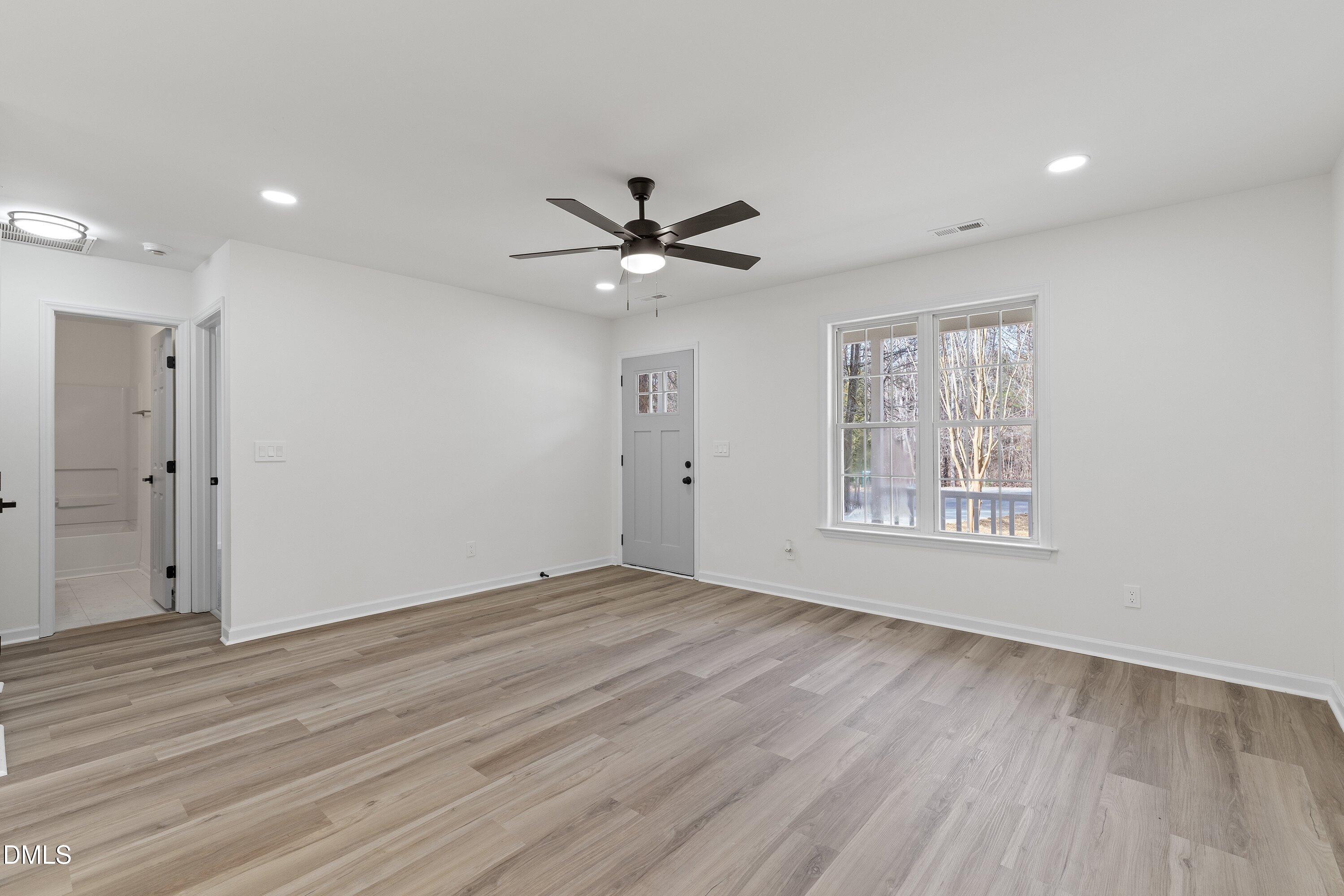 103 Callaway Lane Selma, NC 27576 - Photo 20 of 43 wooden floor in an empty room with a window