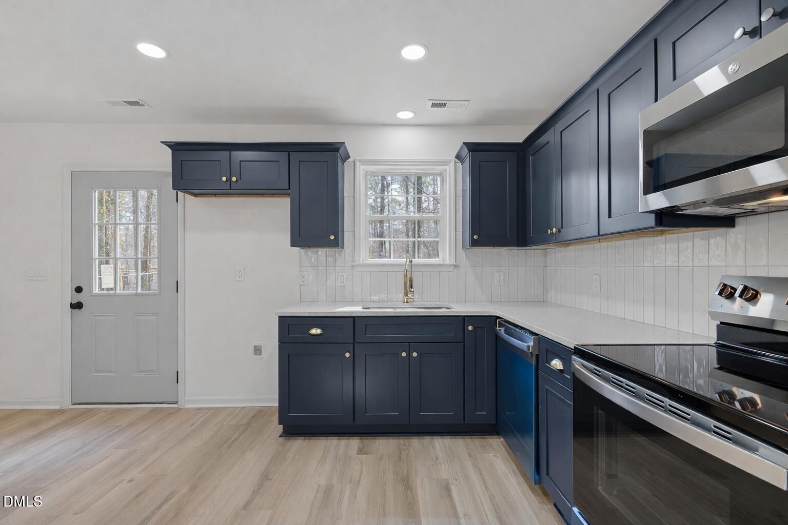 103 Callaway Lane Selma, NC 27576 - Photo 2 of 43 a kitchen with stainless steel appliances granite countertop a sink stove and cabinets