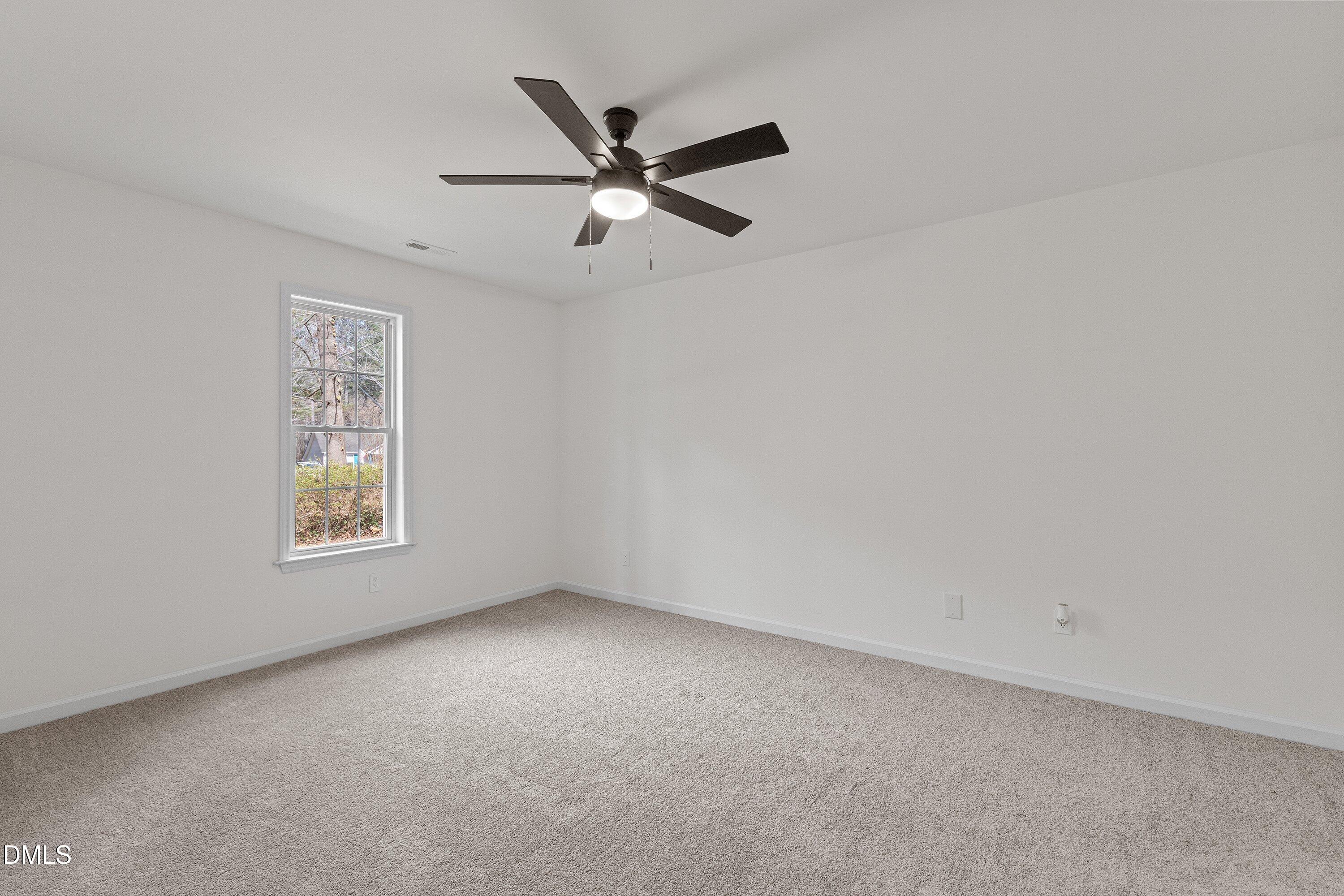 103 Callaway Lane Selma, NC 27576 - Photo 21 of 43 a view of an empty room with a window