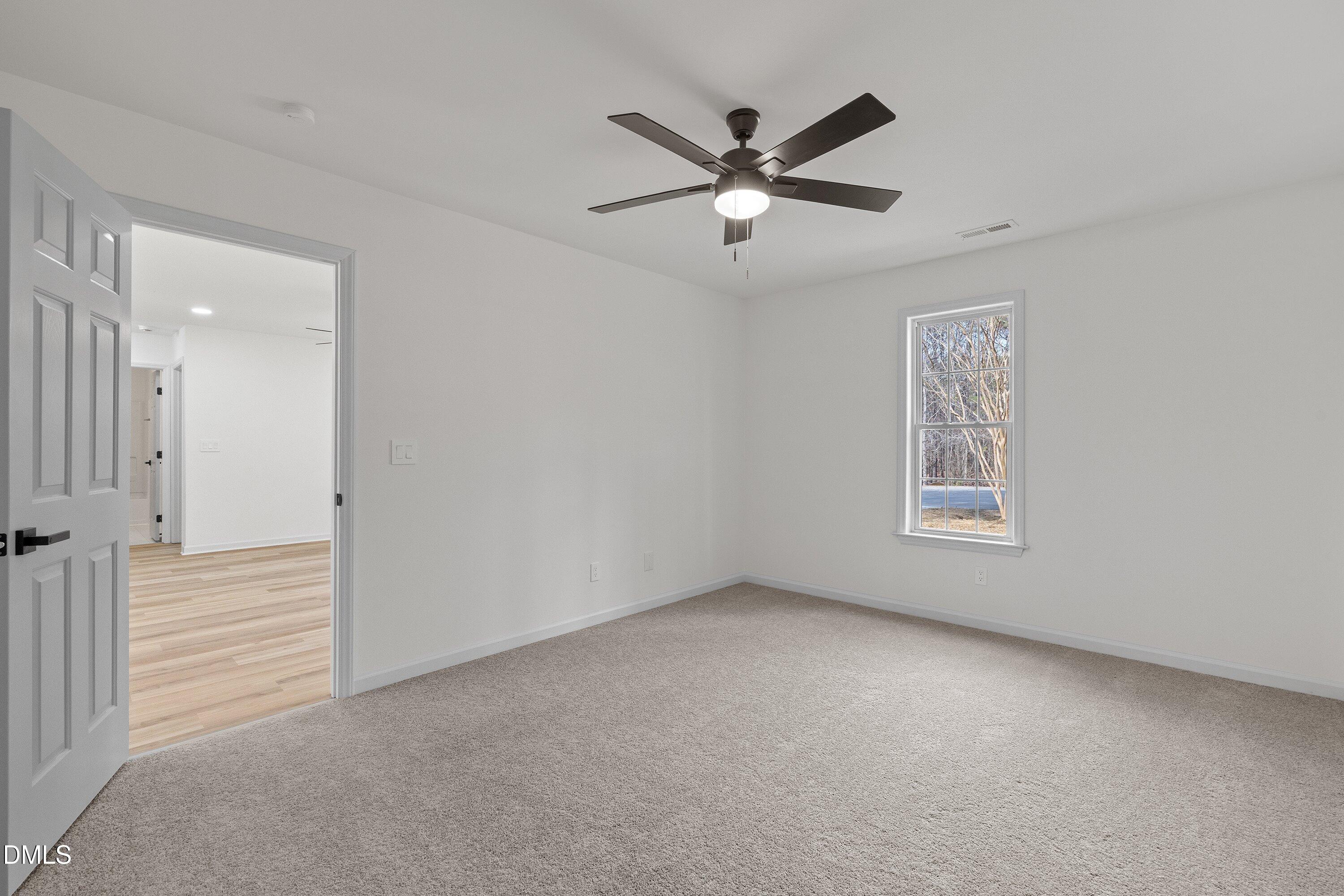 103 Callaway Lane Selma, NC 27576 - Photo 22 of 43 an empty room with a window and a fan