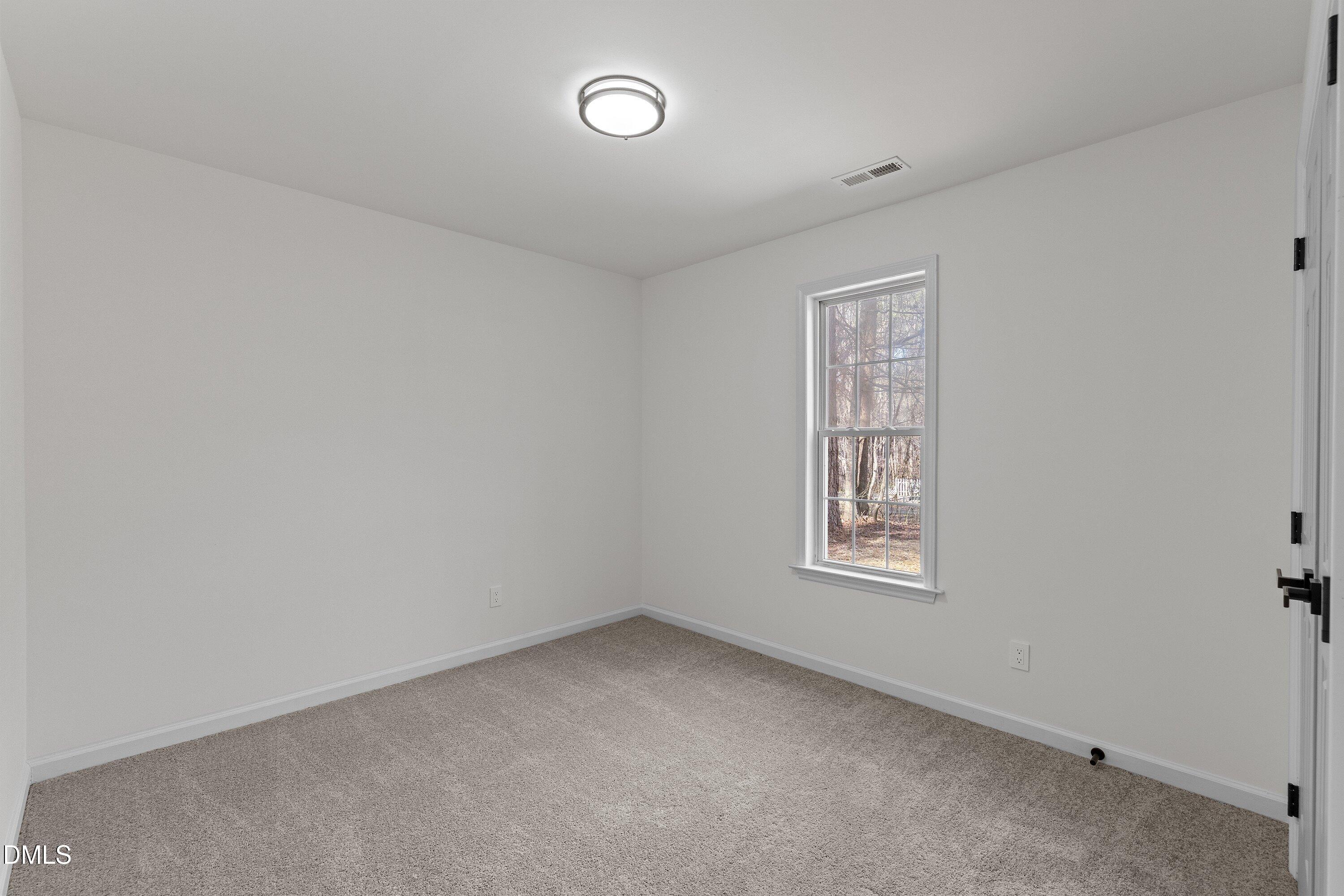 103 Callaway Lane Selma, NC 27576 - Photo 24 of 43 an empty room with a window
