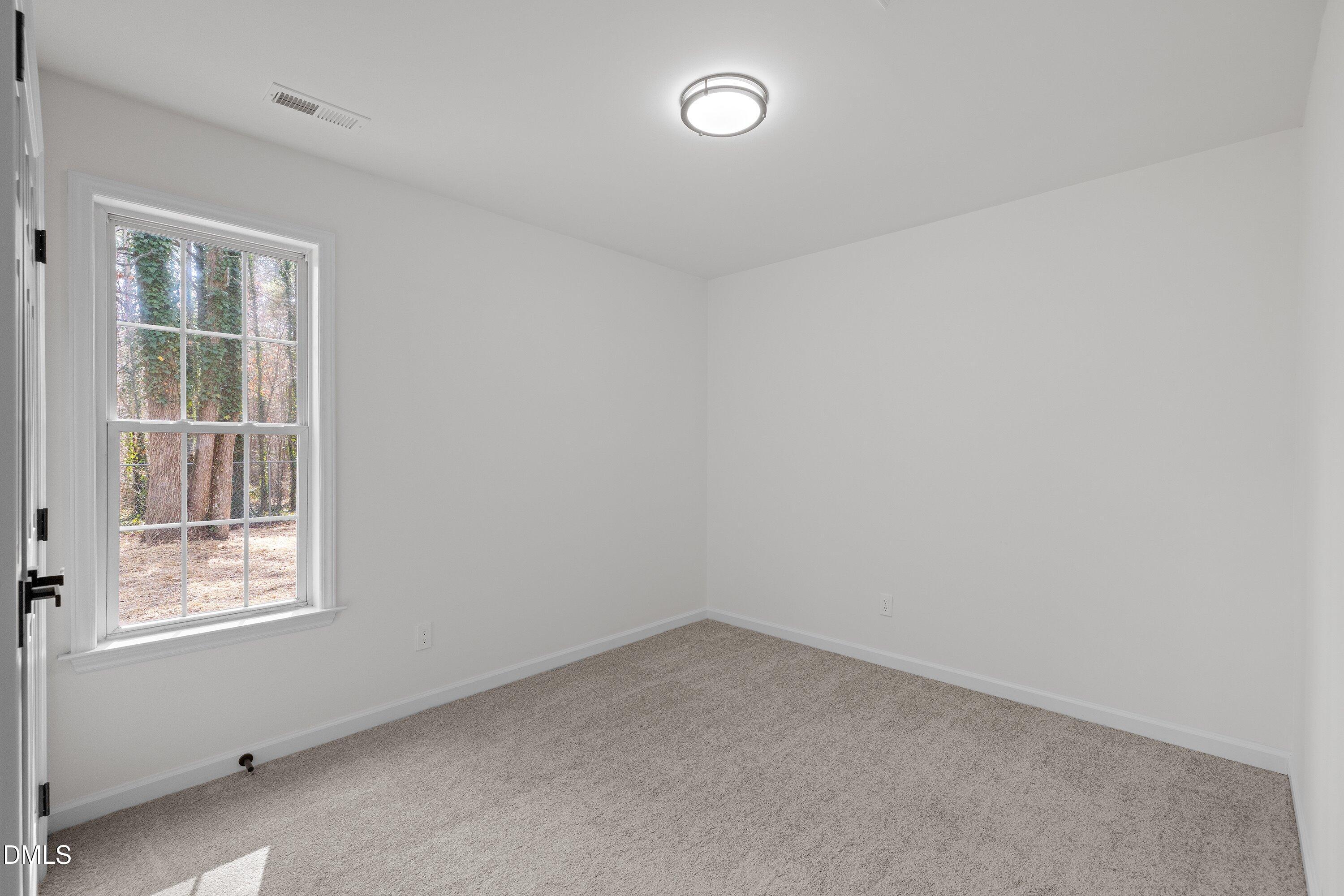103 Callaway Lane Selma, NC 27576 - Photo 26 of 43 an empty room with a window