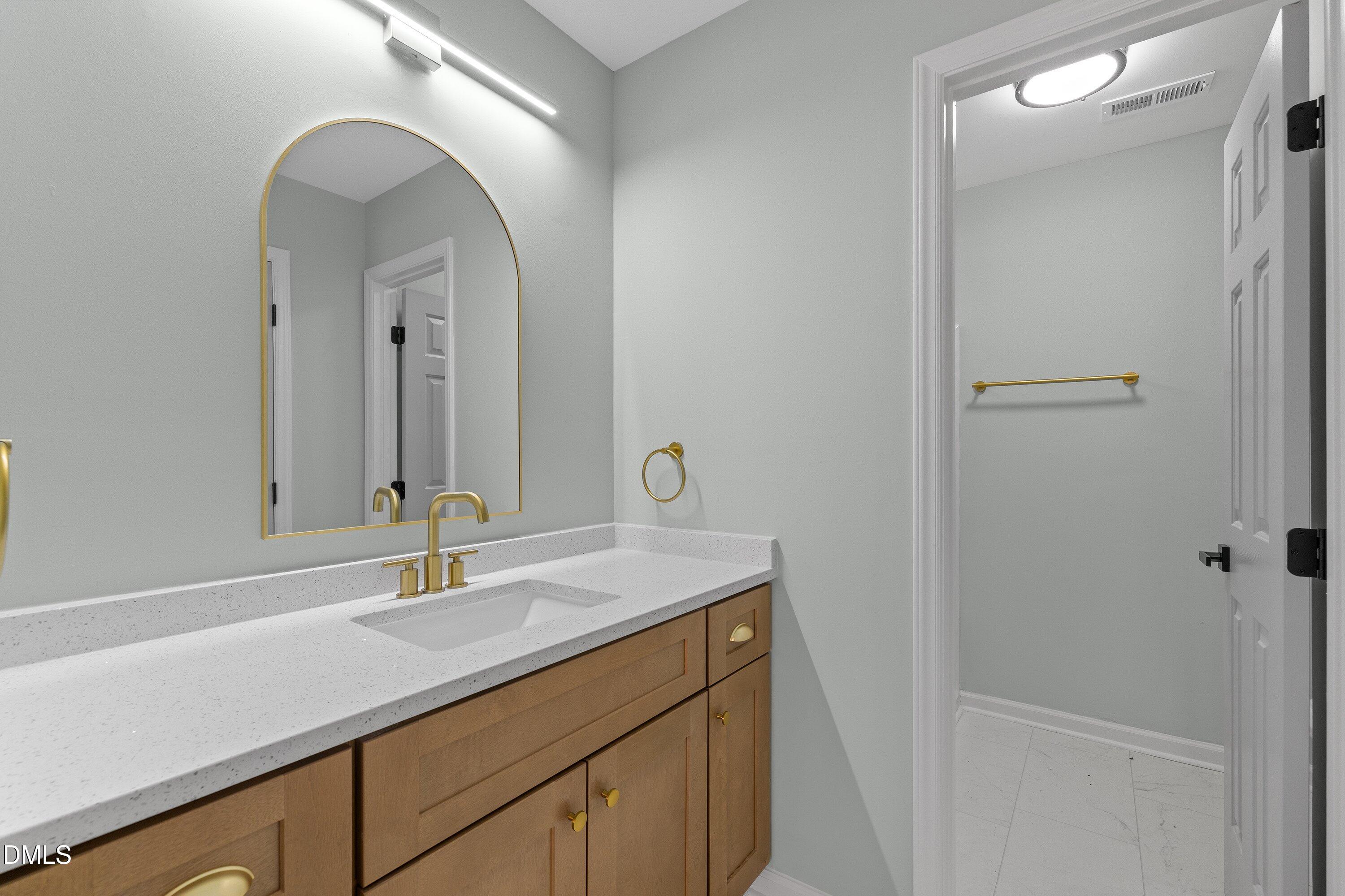 103 Callaway Lane Selma, NC 27576 - Photo 28 of 43 a bathroom with a sink and a mirror
