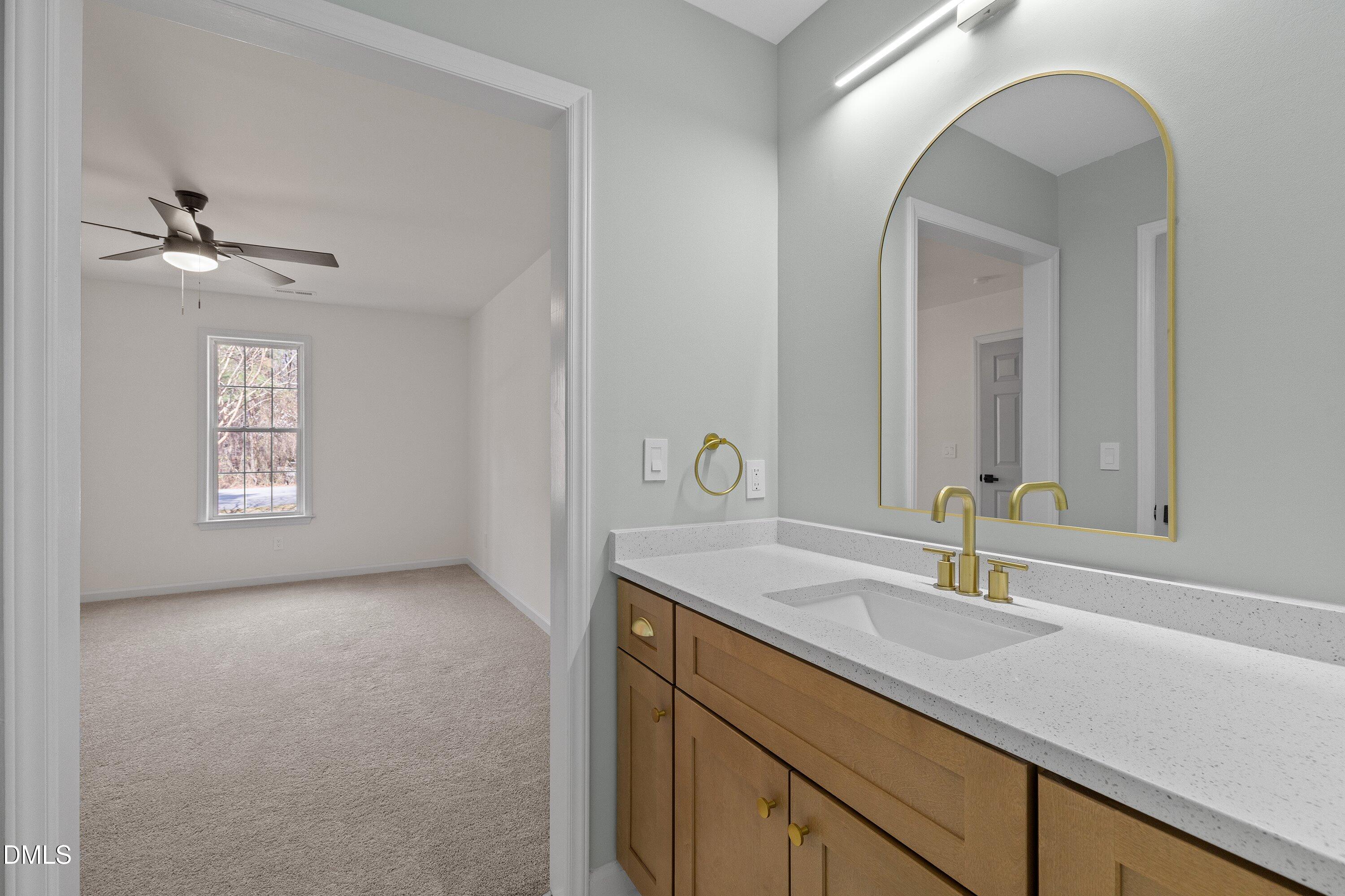 103 Callaway Lane Selma, NC 27576 - Photo 29 of 43 a bathroom with a sink a light fixture and a mirror