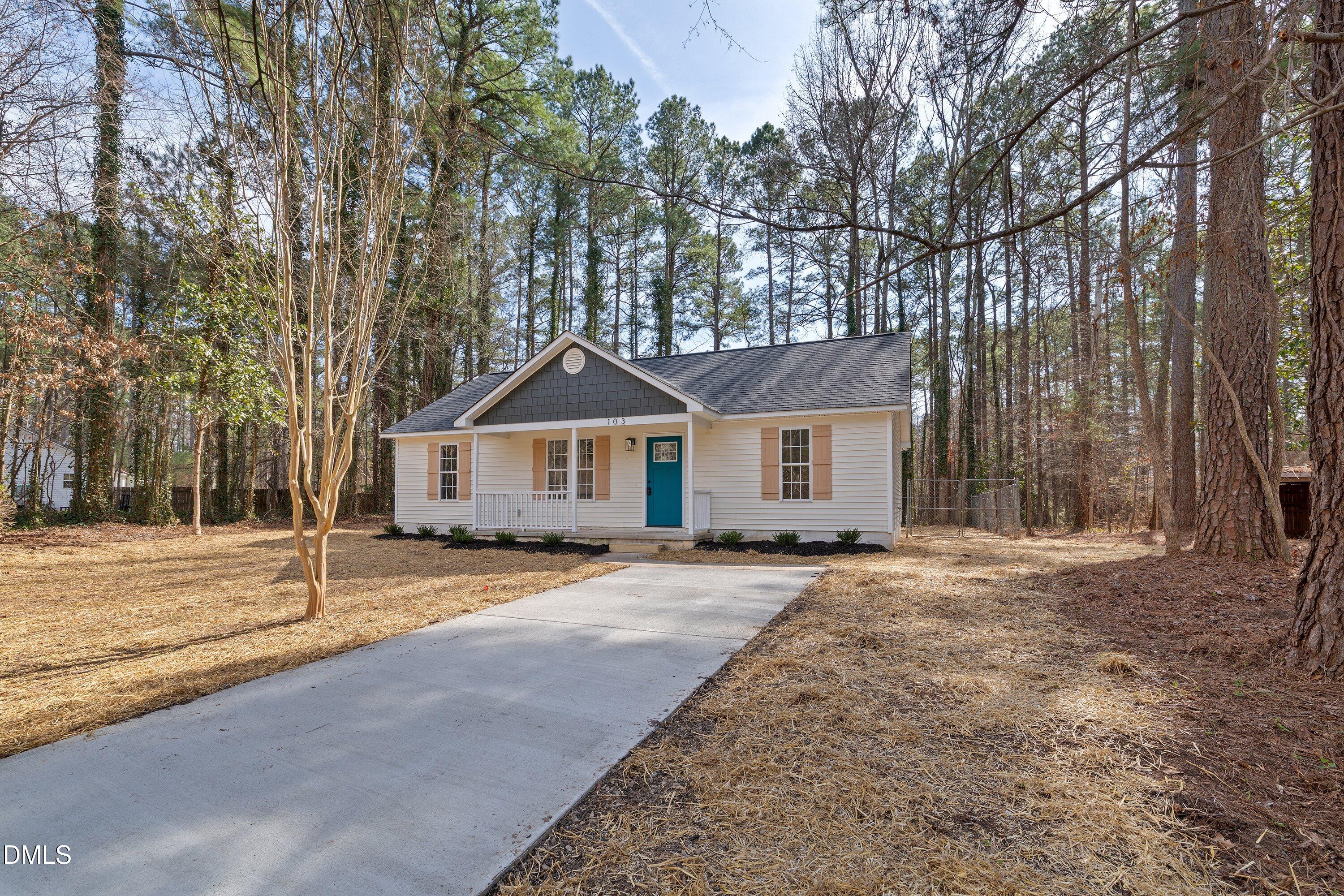 103 Callaway Lane Selma, NC 27576 - Photo 32 of 43 a front view of a house with a yard and garage