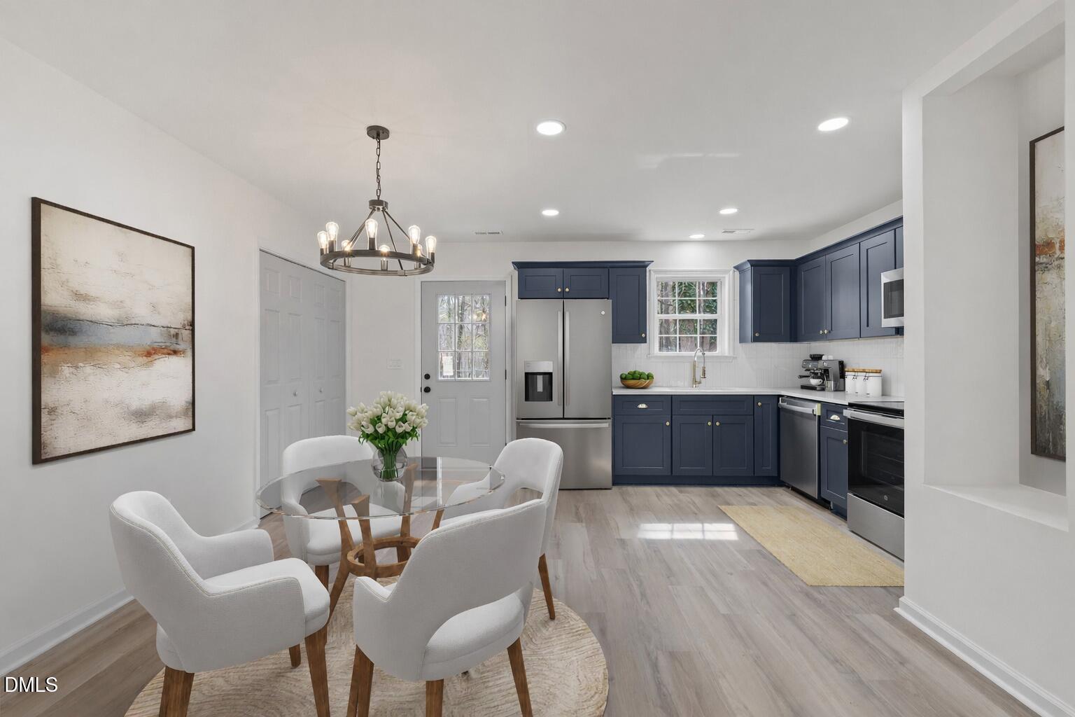 103 Callaway Lane Selma, NC 27576 - Photo 6 of 43 a kitchen with stainless steel appliances granite countertop a refrigerator a sink dishwasher a dining table and chairs