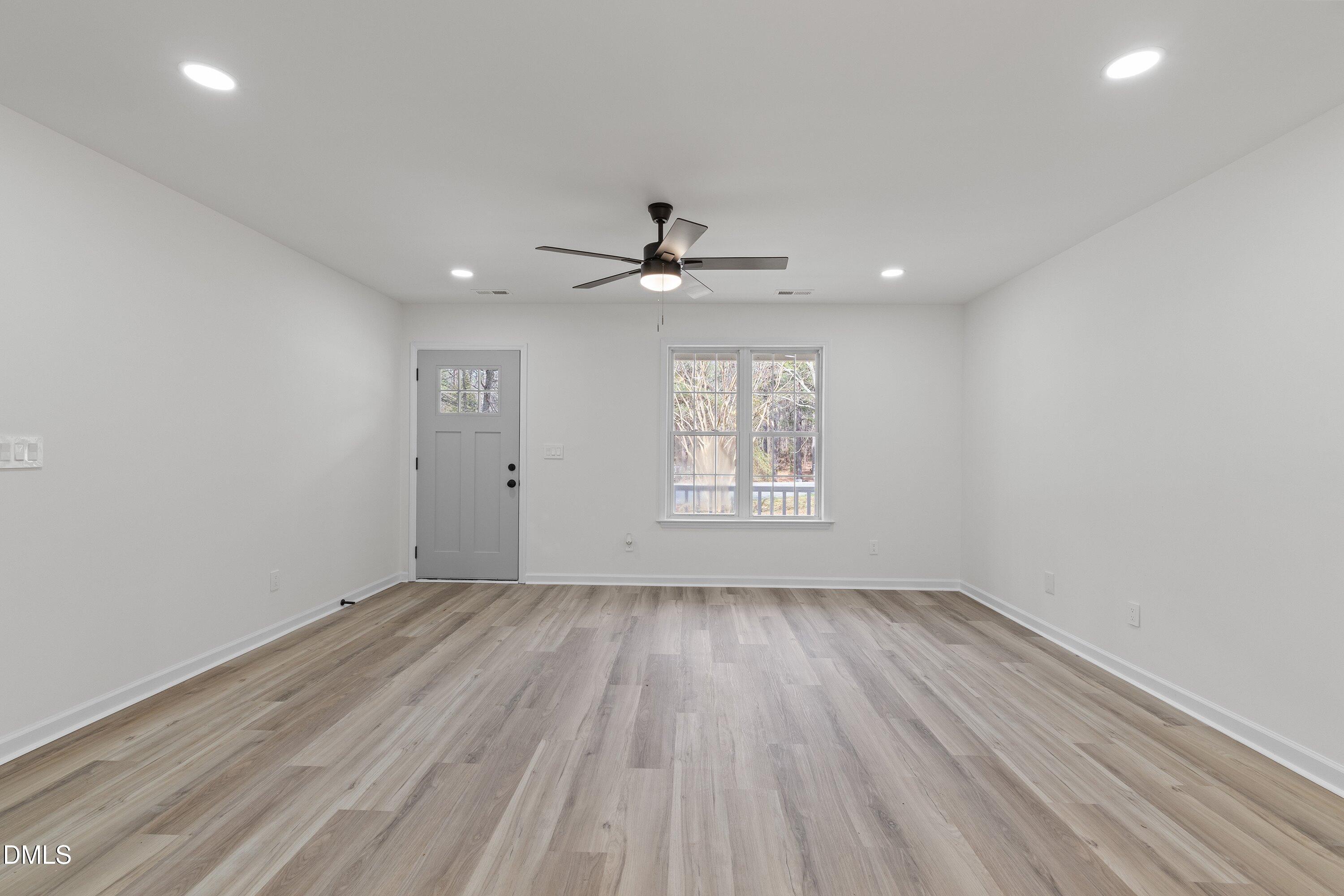 103 Callaway Lane Selma, NC 27576 - Photo 9 of 43 wooden floor in an empty room with a window