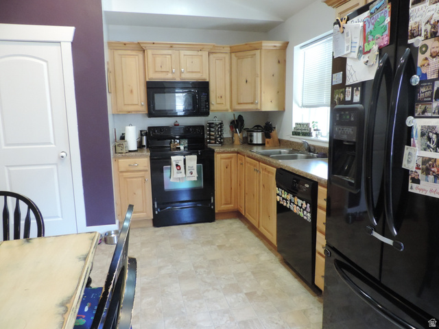 758 South 650 West Logan, UT 84321 - Photo 6 of 18 Kitchen featuring light wood cabinetry, a double basin sink, and a black appliance package including an oven and refrigerator