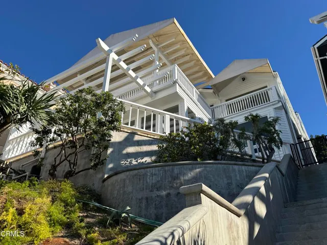 a view of a balcony with lake view and a potted plant