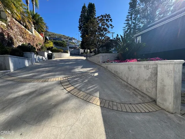 a view of street along with house and trees