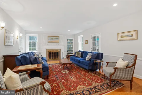 a living room with furniture a rug and a window