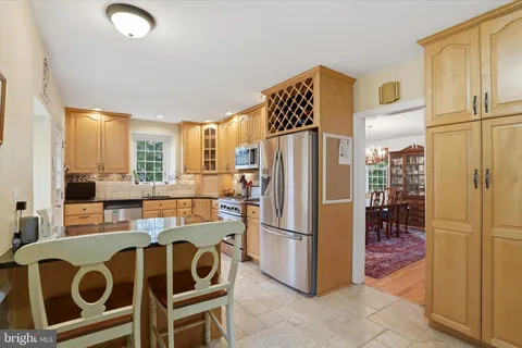 a kitchen with stainless steel appliances a stove microwave and refrigerator