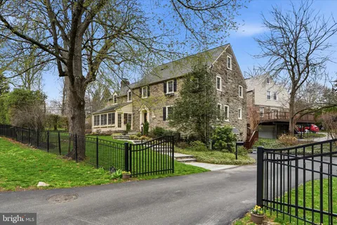 a view of a house with a yard and pathway