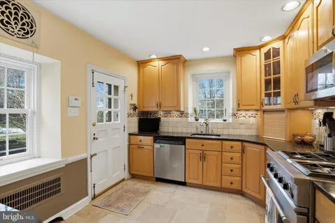 a view of a patio with table and chairs under an umbrella