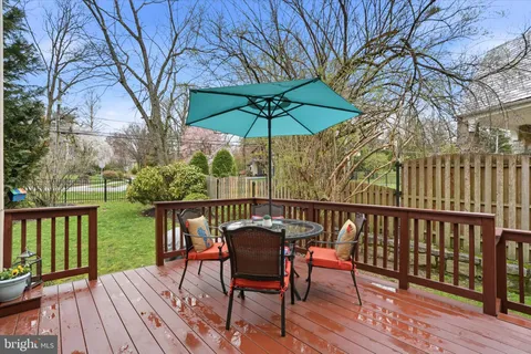 a spacious bedroom with a bed and dresser with mirror
