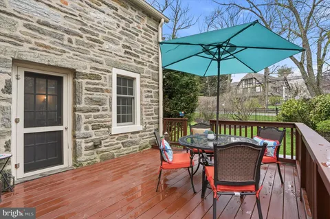 a bedroom with a bed chandelier and a window