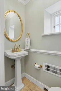 a spacious bathroom with a double vanity sink a mirror and a shower