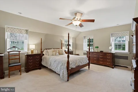 a view of a bedroom with baby crib and furniture