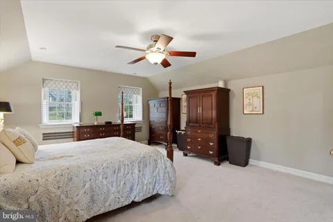 a bedroom with furniture and a window