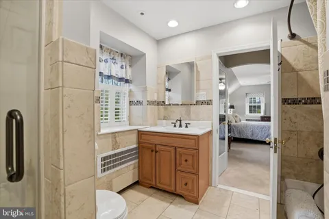 a bedroom with a bed and a couch