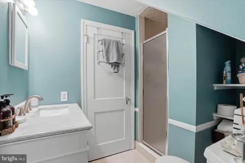 a bathroom with a sink a toilet and mirror