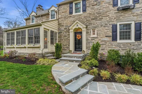 a view of a livingroom with wooden floor and stairs