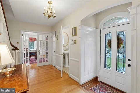 a living room with wooden floor and stairs