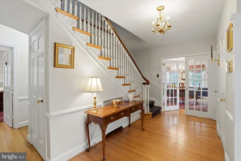 a view of entryway and hall with wooden floor
