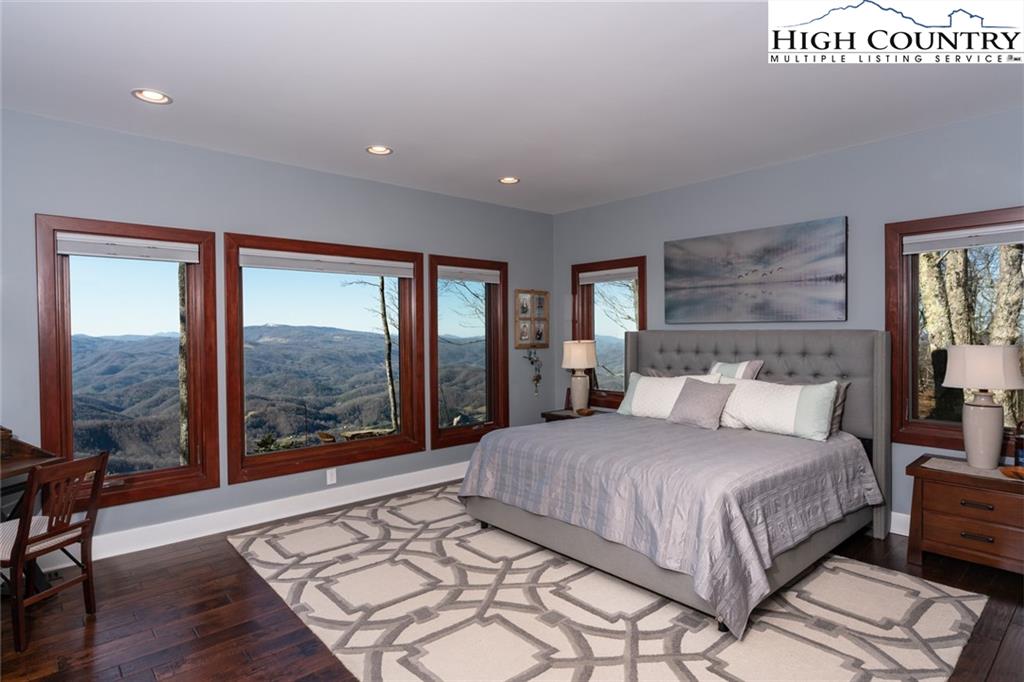 756 Saddle Road Vilas, NC 28692 - Photo 12 of 32 a bedroom with a large bed and a large window