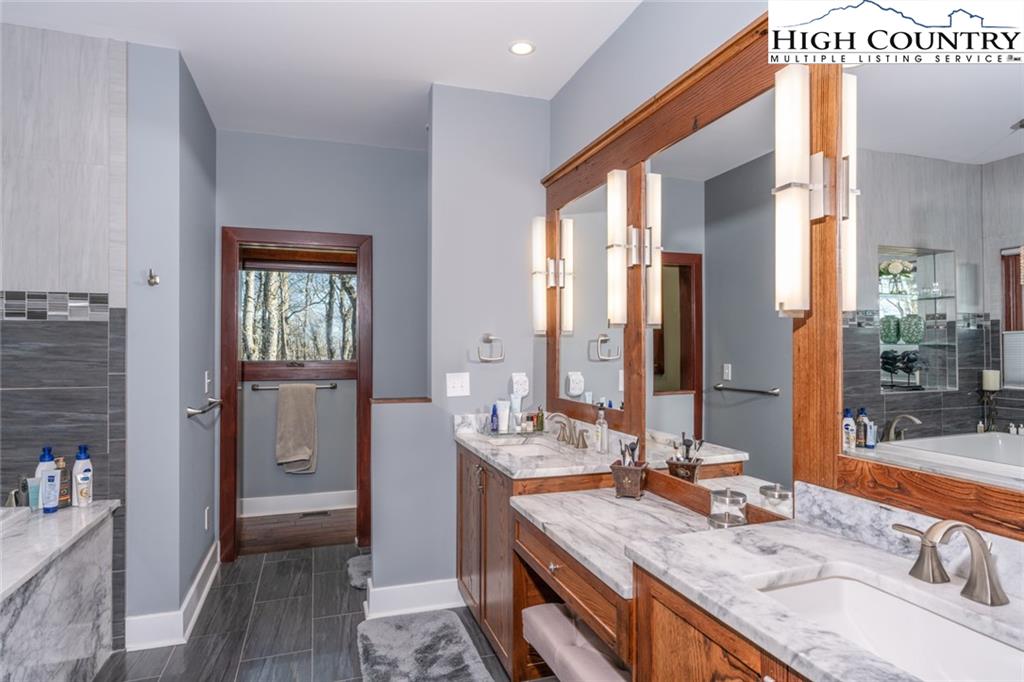 756 Saddle Road Vilas, NC 28692 - Photo 15 of 32 a bathroom with a granite countertop sink and a mirror