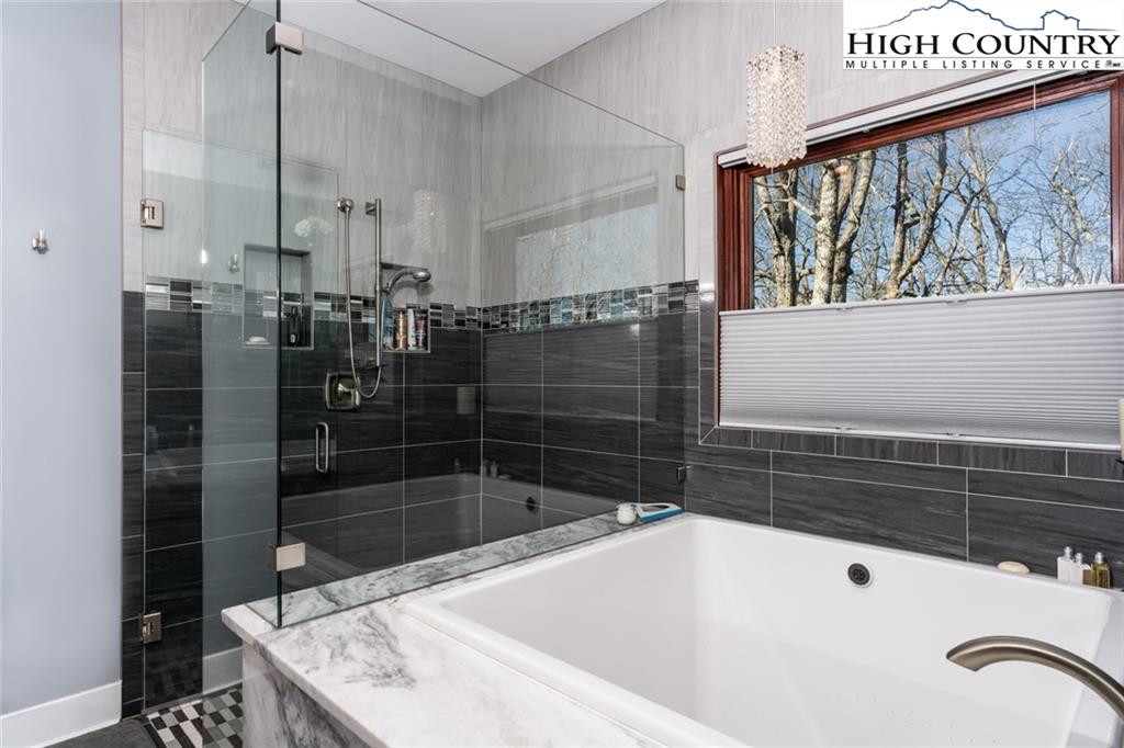 756 Saddle Road Vilas, NC 28692 - Photo 16 of 32 a bathroom with a bathtub and shower