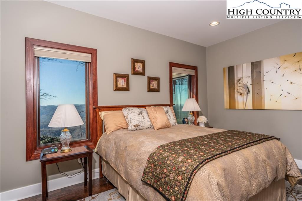 756 Saddle Road Vilas, NC 28692 - Photo 18 of 32 a bedroom with a bed and a lamp