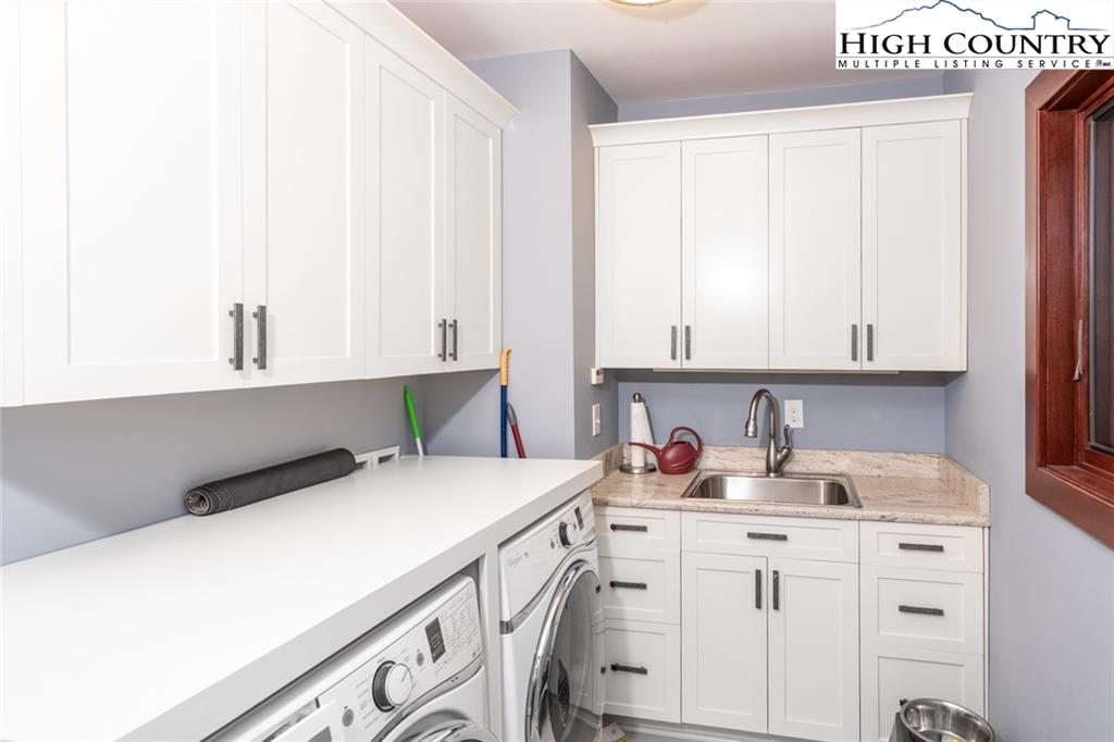 756 Saddle Road Vilas, NC 28692 - Photo 22 of 32 a utility room with cabinets washer and dryer