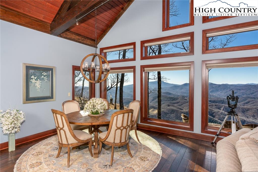 756 Saddle Road Vilas, NC 28692 - Photo 8 of 32 a dining room with furniture large windows and wooden floor