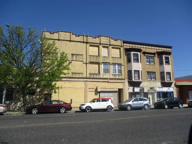 a couple of cars parked in front of a building
